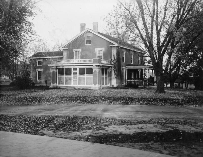 Street view of the farm house with 3 seasons poarch, balcony, and front door visible. 