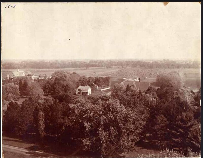 Farm Laborer's Cottage with neighboring houses, farm land, and trees. 