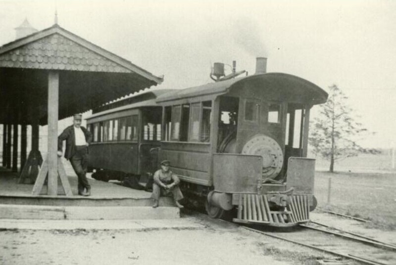 Two men sitting in front of the train at the Hub. 