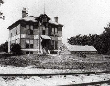 Bevier House in Front of Train Tracks