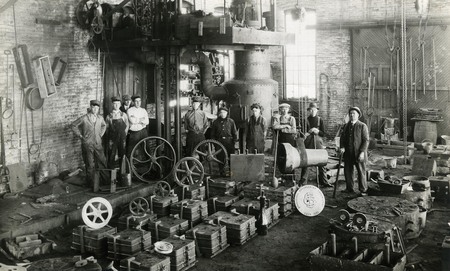 Men standing inside the foundry building