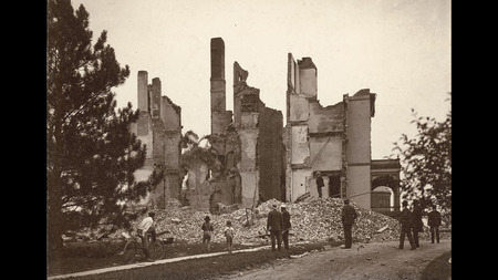 Bystanders looking at the Old Main rubble and fire damage