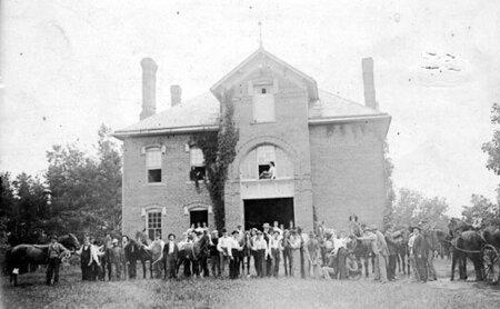 A large group of People and Horses Outside the Veterinary Hospital