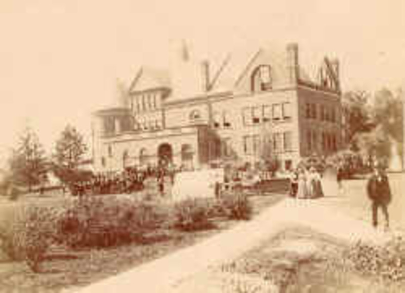 People in period clothing stand along a pathway leading toward the northeast corner of Morrill Hall.
