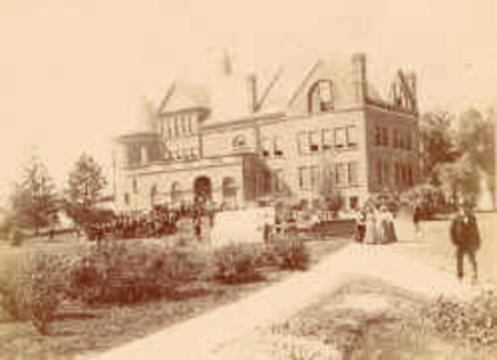 People in period clothing stand along a pathway leading toward the northeast corner of Morrill Hall.